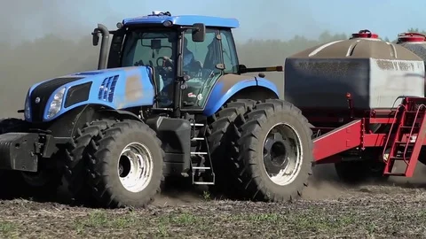 Tractor harvester on sowing. In late spring Stockbeeldmateriaal 74911370