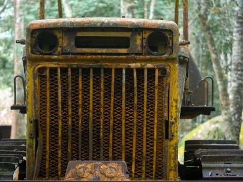 Tractor has rust in front part.Grunge texture background.Dark worn rusty meta Stock Photos