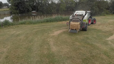 Tractor hay baling in a farm Stock Footage 112984308