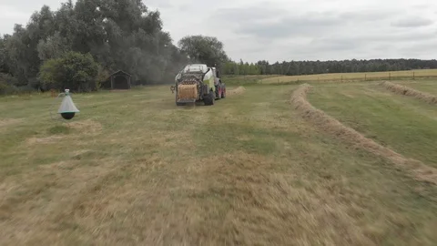 Tractor hay baling in a farm Stock Footage 112984472