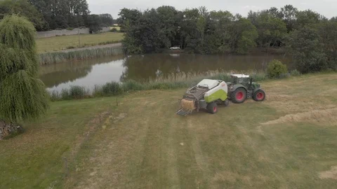 Tractor hay baling in a farm Stock Footage 112984486