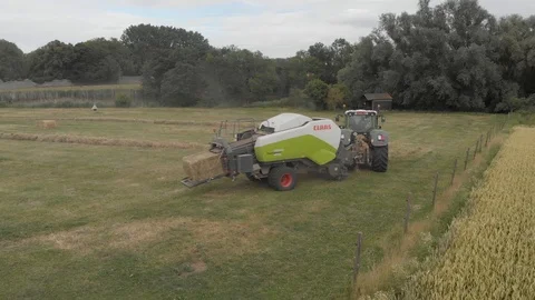 Tractor hay baling in a farm Stock Footage 112984670