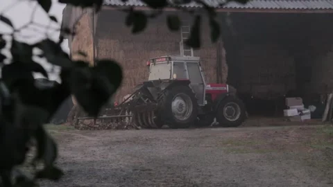 A tractor on his farm during an early morning Vídeos de archivo 166304818