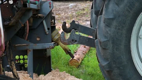 Tractor hitching up to a woodcutter Video stock 334960591