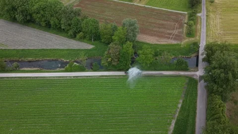 Tractor irrigating actively growing crops on farmland during spring 動画素材 334228433