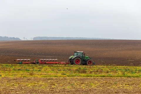 A tractor with a large double plow Stock Photos