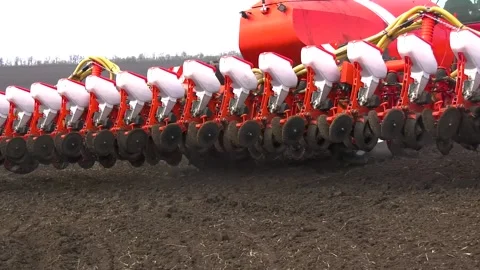 A tractor with a large seeder is deployed in the field during field work. Sowing Video stock 239263025