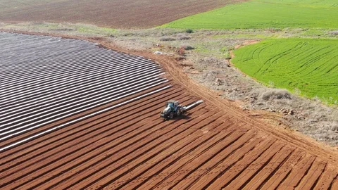 Tractor laying plastic mulch Stock Footage 125845134