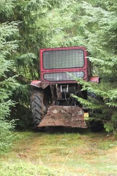 Tractor left in the woods Stock Photos