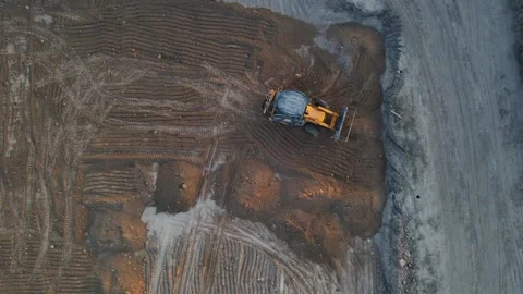 The tractor levels the surface of the ground Video stock 256261877