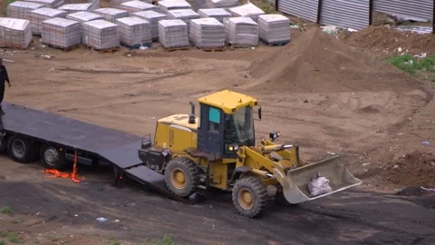 The tractor is lifted onto the loader Stock Footage 247504629