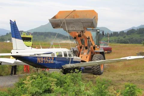 Tractor Lifting Crashed Airplane  Stock Photos
