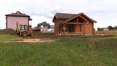 Tractor line up land plot with soil near country house Stock Footage 83241513