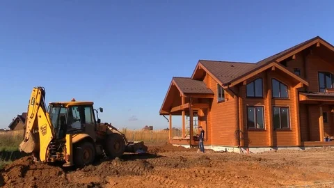 Tractor line up land plot with soil near country house Stock Footage 83241537