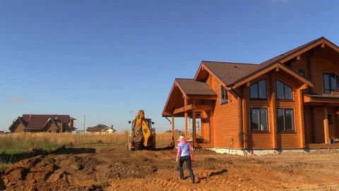 Tractor line up land plot with soil near country house Stock Footage 83241542