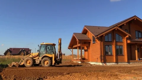 Tractor line up land plot with soil near country house Stock Footage 83241567