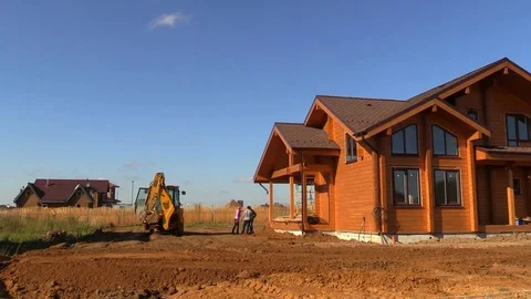 Tractor line up land plot with soil near country house Stock Footage 83241568