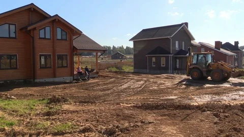 Tractor line up land plot with soil near country house Stock Footage 83241602