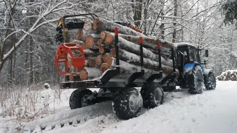 Tractor with loaded trailer logs trying to get off the road Stock Footage 169549014