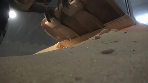 Tractor-loader loads brown sugar in storage silos, close up Stock Footage 131637845