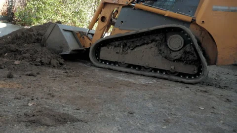 The tractor loader is picking up soil with its large bucket Stock Footage 147935089