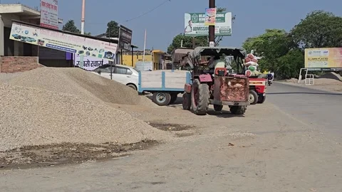 Tractor Loading Stone and Sand into Trolley, Rural India Stock Footage 313571225