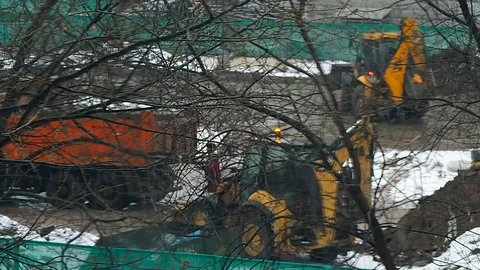 Tractor is loading of truck on the construction site in the winter 스톡 동영상 97523031