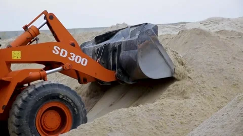 The tractor loads crushed stone and sand. Automated production line for paving Stock Footage 244713108
