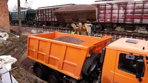 The tractor loads the rubble into the truck. Stock Footage 196087782