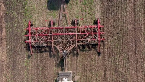 A tractor with a machine to remove weeds on the field, view from above. Special Stock Footage 154369524