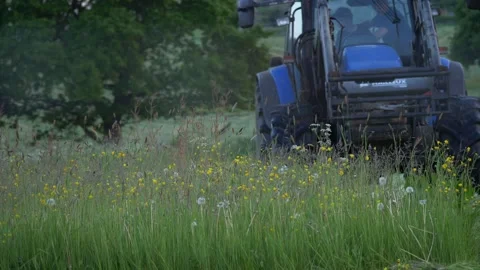 Tractor machinery driven by farmer in meadow Stock Footage 155621248