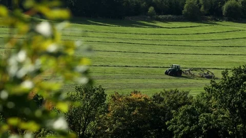A tractor making hay in the countryside 4k 25fps video Stock-Footage 317514899