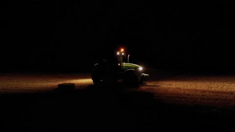 A tractor in the middle of the field at night. Night view of the tractor. Video stock 158617066