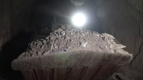 Tractor in the mine is collecting ore in a bucket. Excavator collects stones int Stock Footage 96446341
