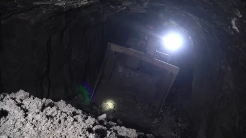 Tractor in the mine is gaining ore into the bucket.The excavator collects stones Stock Footage 96447260