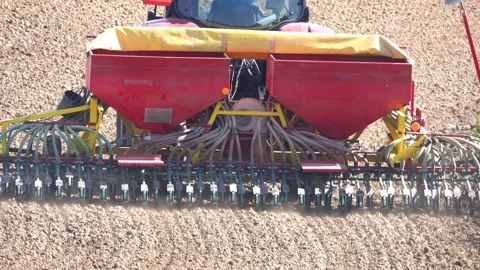 Tractor with modern pneumatic seeder prepares the land for sowing grain Stock Footage 138647384