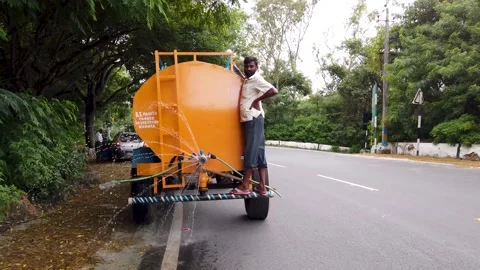 A Tractor in motion Sanitizing a street of Mysore, India. Stock Footage 158469168
