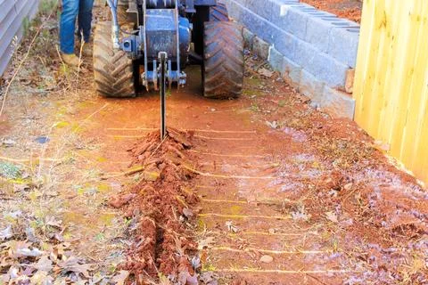 Tractor mounted trencher cable plows are used to lay fiber optic a cables Stock Photos