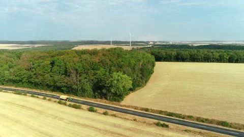 Tractor Moving Haystack on Road Surrounded by Dried Out Fields - France 4K Drone Stock Footage 259847533