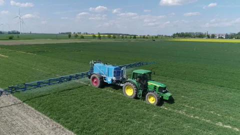 Tractor moving on rape field. Preparing for fertilizing Stock Footage 86467202