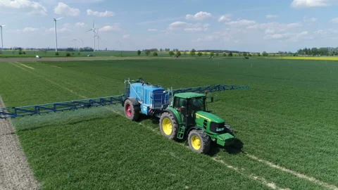 Tractor moving on rape field. Preparing for fertilizing Stock Footage 86467220