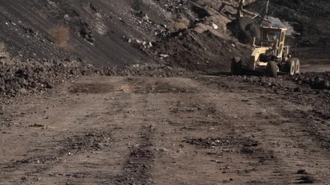 Tractor moving towards the camera at a coal mine in Greece Stock Footage 121016049