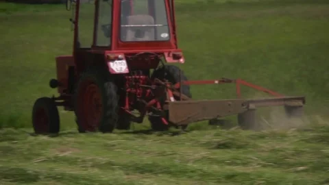 Tractor mowing grass in the field Stock Footage 85327339