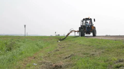 Tractor mowing grass Stock Footage 65412580
