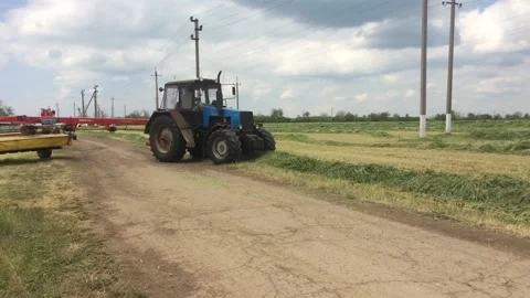 Tractor mowing hay on the field Stock Footage