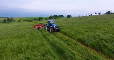 Tractor mows the grass in the field Stock Footage 132622855