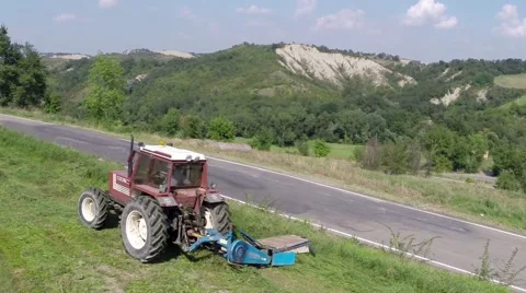 Tractor mows the grass on the mountains3.mp4 Stock Footage 42693611