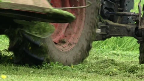 Tractor mows a meadow in spring Stock Footage 303962711