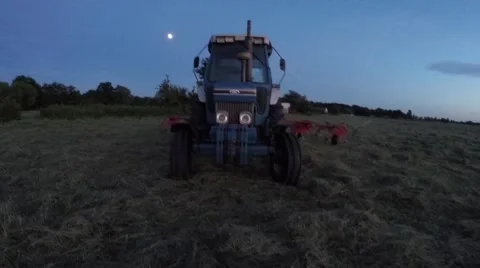 Tractor at night camera drop satellite zoom very fast filmed by drone 4k Stock Footage 52178994