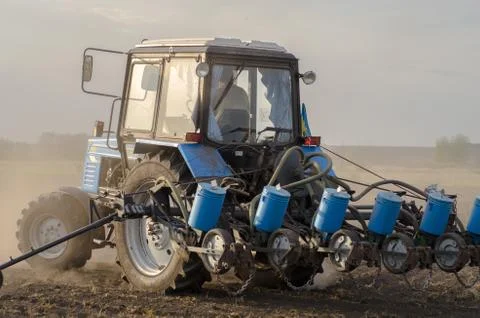 Tractor with old seeder Foto stock